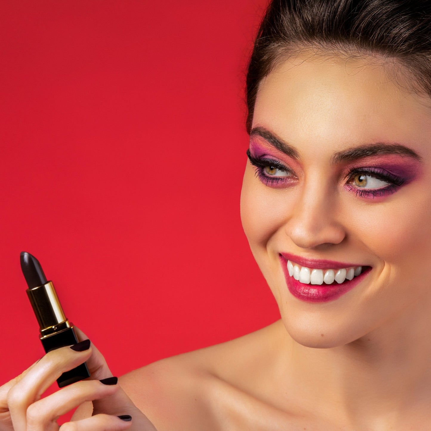 Woman applying black color-changing lipstick with lip stain finish
