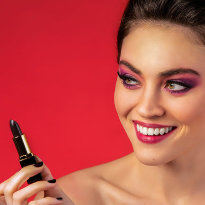 Woman applying black color-changing lipstick with lip stain finish