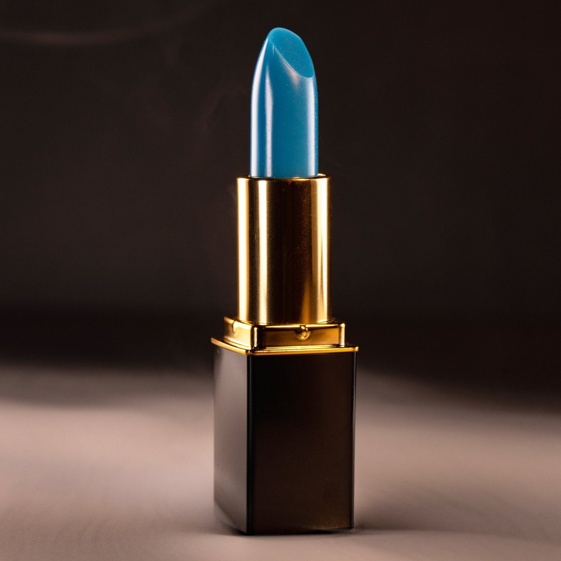Close-up of blue lipstick bullet in gold L’Paige casing