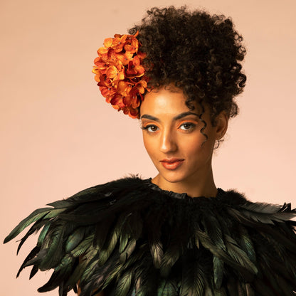 Model wearing L’Paige brown shade-adapting lipstick with raspberry-red finish