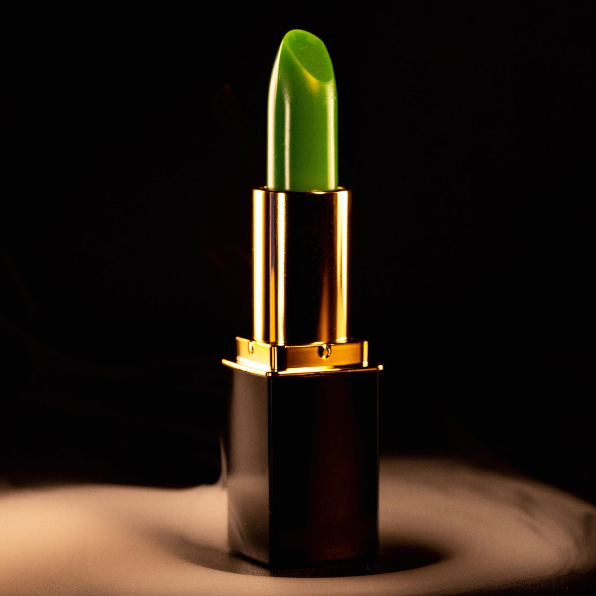 Green shade-adapting lipstick by L’Paige shown in studio lighting