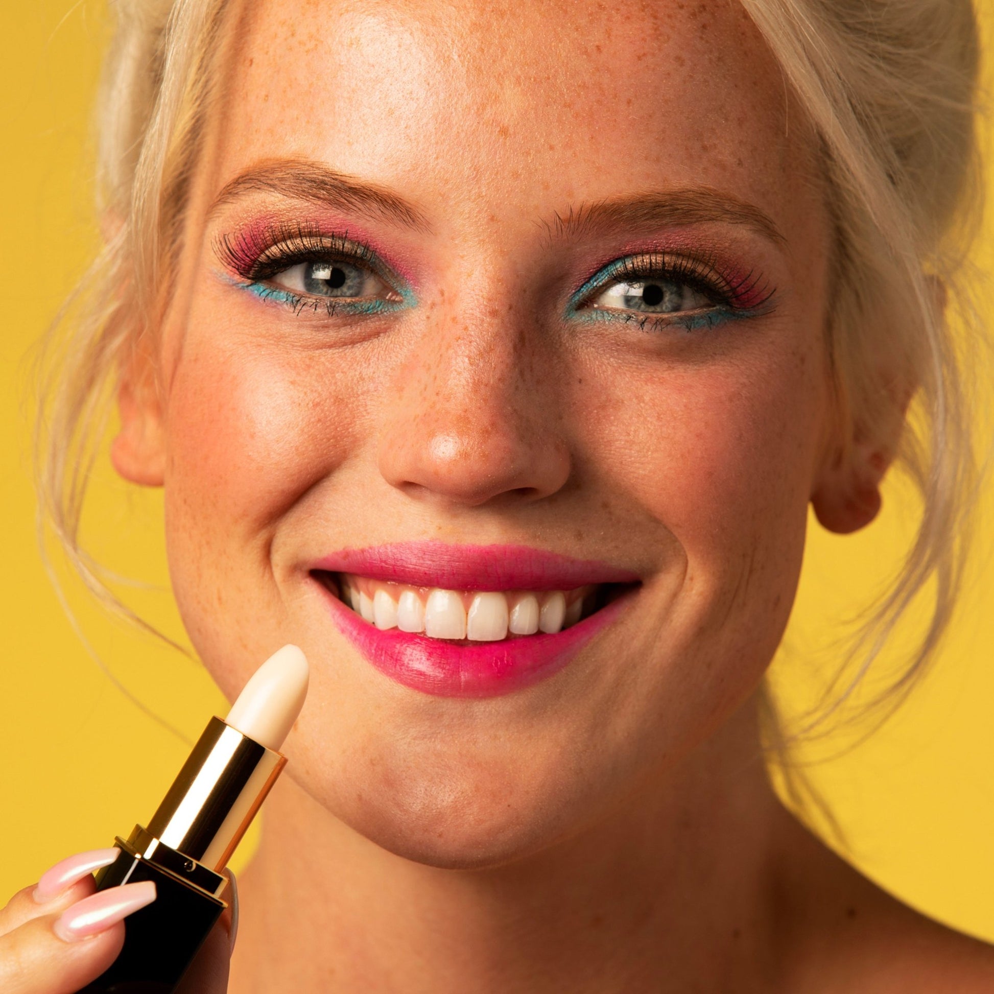 Woman applying white color-changing lipstick with rose-pink lip stain finish