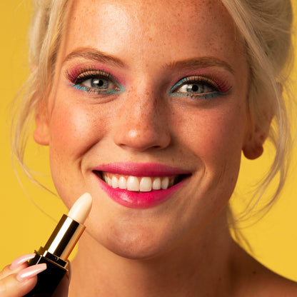 Woman applying white color-changing lipstick with rose-pink lip stain finish